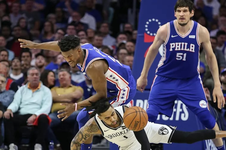 Sixers' Jimmy Butler collides with Nets' D'Angelo Russell  during the 2nd quarter of Game 5 of the first round of the NBA playoffs at the Wells Fargo Center in Philadelphia, Tuesday, April 23, 2019.