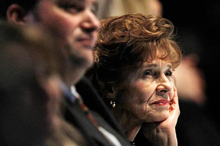 Sue Paterno and son Scott watch a video presentation during the memorial at Bryce Jordan Center. (Laurence Kesterson / Staff Photographer)
