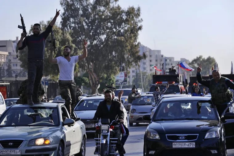 Syrian soldiers dance as they chant slogans against U.S. President Trump during demonstrations following a wave of U.S., British and French military strikes to punish President Bashar Assad for suspected chemical attack against civilians, in Damascus, Syria, Saturday, April 14, 2018. Hundreds of Syrians are demonstrating in a landmark square in the Syrian capital, waving victory signs and honking their car horns in a show of defiance.