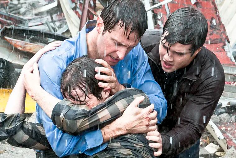 This image released by Warner Bros. Entertainment shows clockwise from foreground, Max Deacon, Richard Armitage, and  Nathan Kress in a scene from "Into The Storm." (AP Photo/Warner Bros. Entertainment, Ron Phillips)