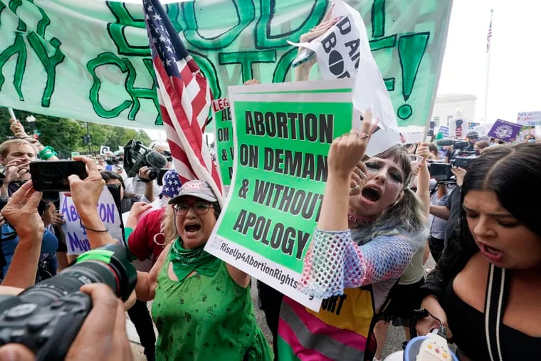 People protest outside the Supreme Court in Washington on Friday, June 24, 2022, following the news that the Supreme Court overturned Roe v. Wade.