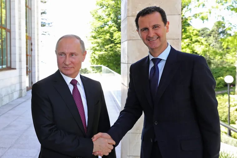 In this May 17, 2018, file photo, Russian President Vladimir Putin, left, shakes hands with Syrian President Bashar al-Assad during their meeting in the Black Sea resort of Sochi, Russia.