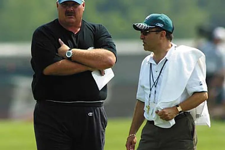 Andy Reid and Joe Banner stay in constant communication with each other. (Yong Kim / Staff file photo)