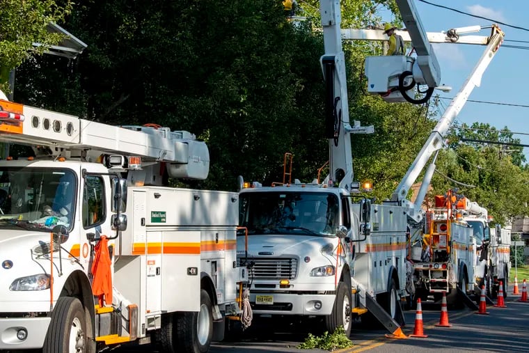 Utility crews from PSE&G work along 3rd Avenue to restore power in Barrington on Wednesday. Many homeowners in the borough were still without power from Isaias.