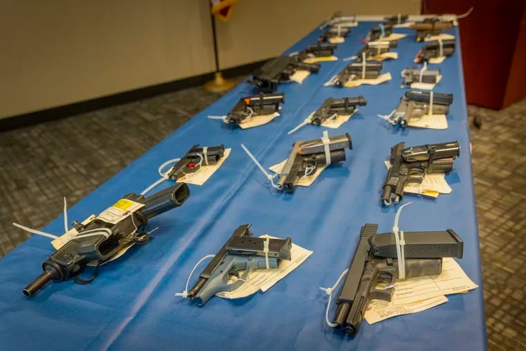 Guns seized during an investigation displayed at a federal Bureau of Alcohol, Tobacco, Firearms and Explosives (ATF) press conference held on April 11, 2022.