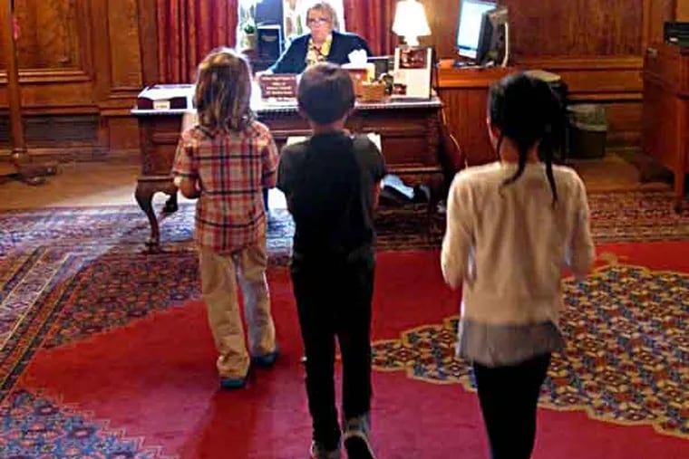 File photo: Children deliver letters written by Philadelphia public school students to the office of Gov. Tom Corbett on Wednesday, June 12, 2013, in Harrisburg, Pa. (AP Photo/Marc Levy)
