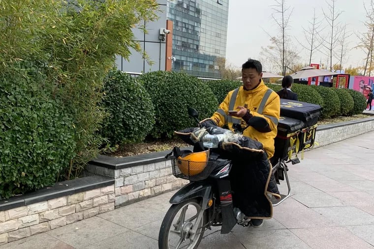 In Beijing, a driver delivers food for Meituan Dianping, the national meal delivery app that delivers fresh groceries anywhere in 30 minutes and just marked a high of 30 million orders in one day.