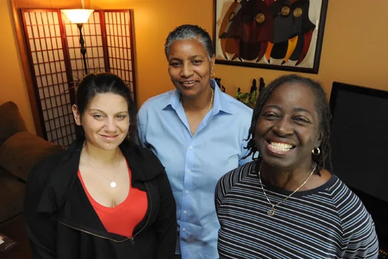 At her Lawnside, NJ home, Cheryl Marlowe, director of The Lioness Pride (center) with client Leah Sabatino, left, of Philadelphia; and Sharon Walden, right, exec. director of The Lioness Pride.  (APRIL SAUL / Staff Photographer)