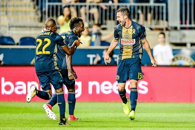 Chris Pontius (right) celebrates with Fafa Picault (left) and C.J. Sapong) center after scoring one of his two goals in the Philadelphia Union’s 3-1 win over the Chicago Fire.