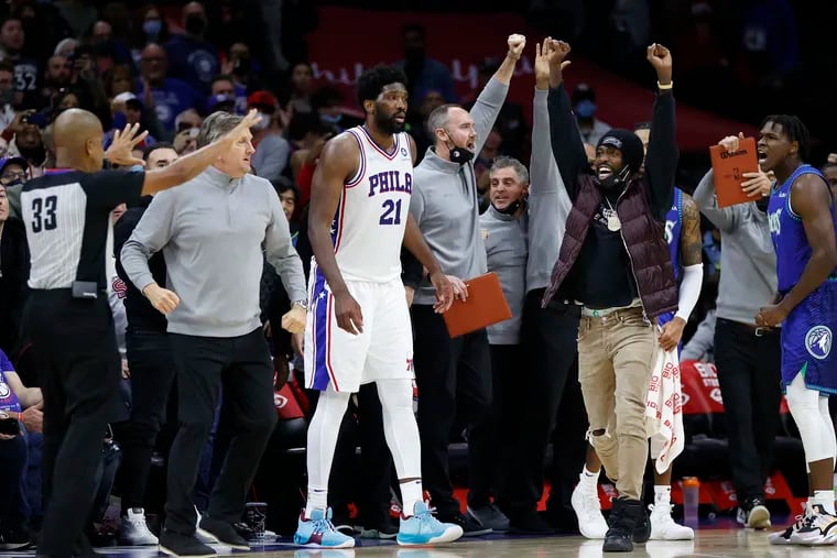 The Minnesota Timberwolves bench celebrates after Sixers center Joel Embiid missed a last-second shot in the second overtime on Saturday.