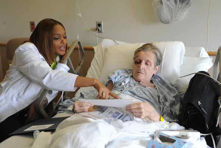 Tanda Medley, a licensed practical nurse and patient navigator, advises Robina Barnes before her discharge from Albert Einstein Medical Center.