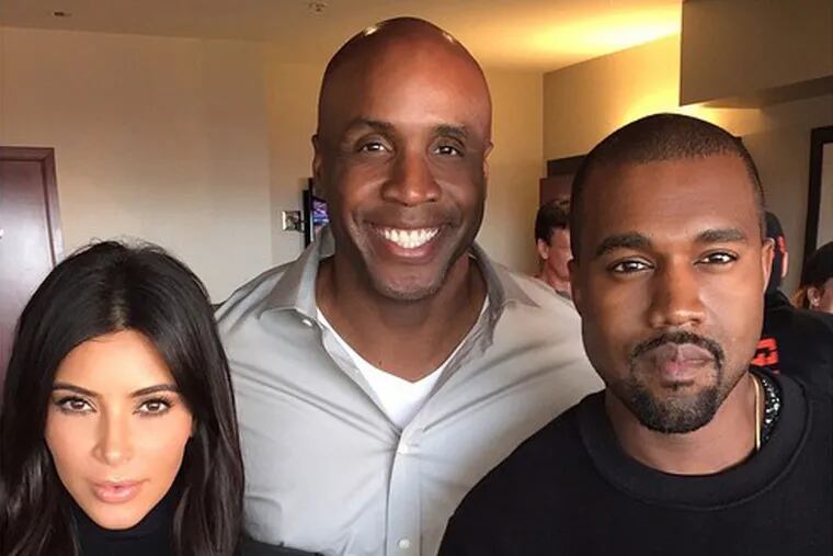 Kim Kardashian, Barry Bonds and Kanye West at San Francisco’s AT&T Park to watch the Giants-Royals World Series game, and to mark the one-year anniversary of the couple’s engagement.