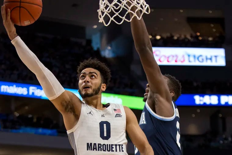 Marquette guard Markus Howard, left, goes up for a basket against Villanova during the first half of an NCAA college basketball game Saturday, Feb. 9, 2019, in Milwaukee.