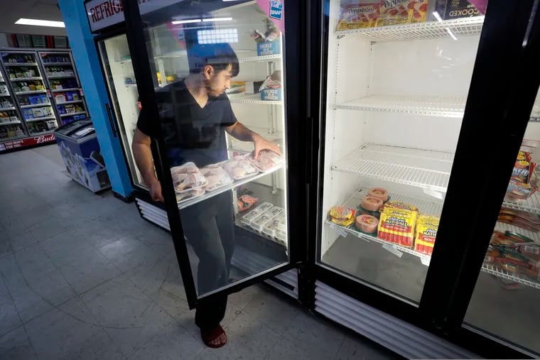 Hardik Kalra stocks meat in a cooler at a local super market, Friday, May 29, 2020, in Des Moines, Iowa.
