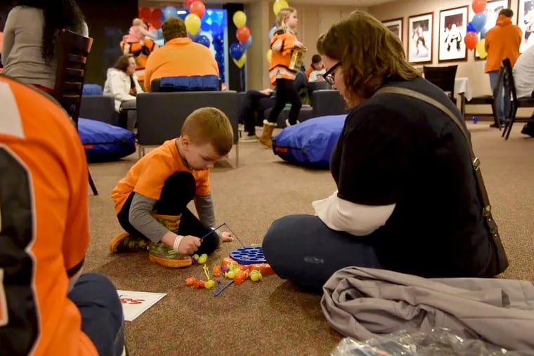 Kelly Polaski and her son Dylan, 5, play in the sensory-friendly lounge between periods at the Wells Fargo Center during the Flyers-Panthers game last week.