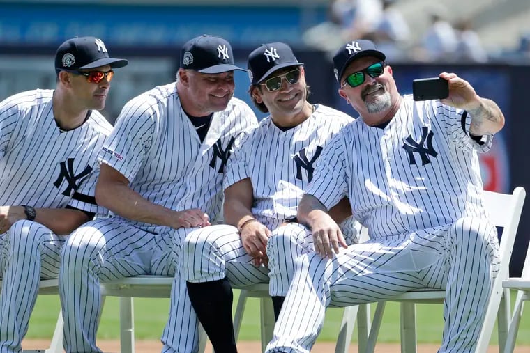 Former Yankee David Wells (right) took a selfie with Johnny Damon (second from right), Jason Giambi (second from left), and current manager Aaron Boone during Old Timers Day at Yankee Stadium on June 23.