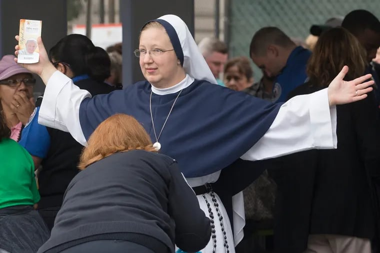 A nun from The Sisters of Life, of New York City, is inspected at a security checkpoint as she arrives for a Mass to be celebrated by Pope Francis, Sunday, Sept. 27, 2015, in Philadelphia.