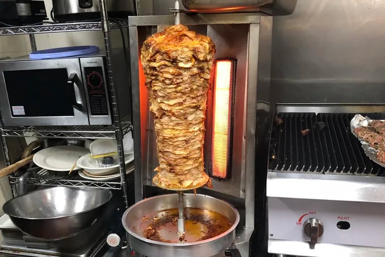 The chicken shawarma roasting on a spit at Al Amana Grocery is a Friday specialty.