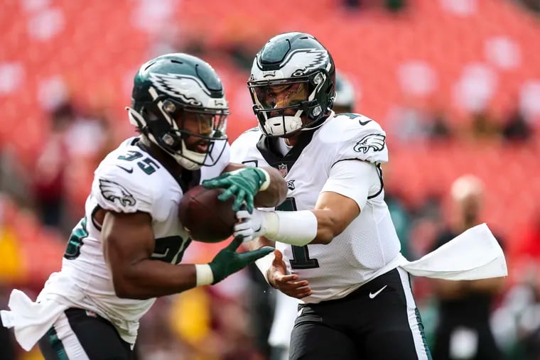 Philadelphia Eagles quarterback Jalen Hurts (1) hands off to running back Boston Scott (35) during warm ups before the Philadelphia Eagles game against the Washington Football Team at FedEx Field in North Englewood, MD on Sunday, January 2, 2022.
