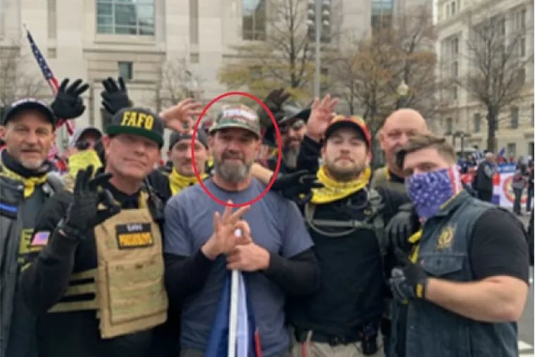 Salvatore Vassallo, center, poses for a photograph making a "white power" symbol with men federal prosecutors identified as members of the Proud Boys. Vassallo was sentenced Wednesday for shoving a police officer during the Jan. 6, 2021, riot at the U.S. Capitol.