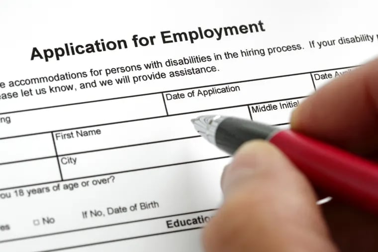 Completing a job application form with focus on heading