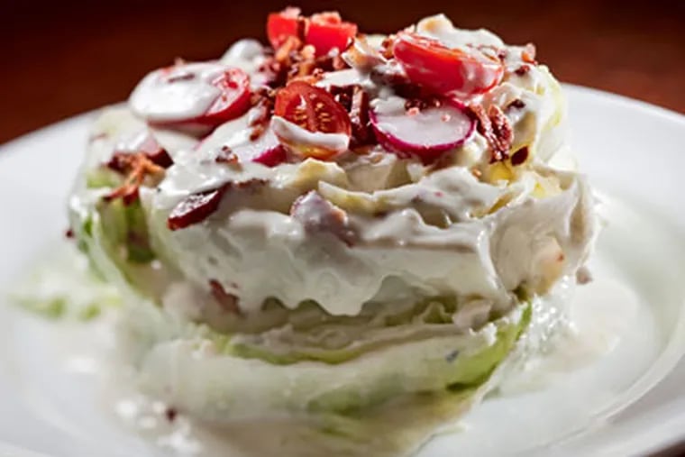 The iceberg salad is reshaped, with blue-cheese dressing, Kentucky bacon, and baby tomatoes. (David M Warren / Staff Photographer)