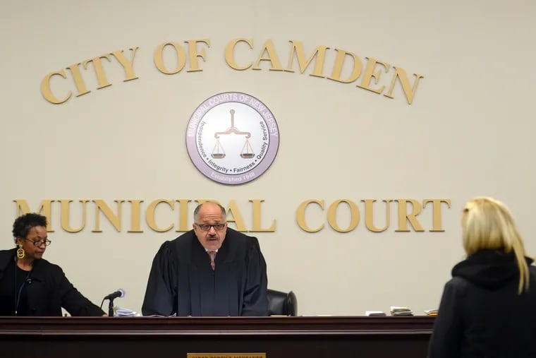 Judge Teofilo Montanez-Santiago presides in Camden Municipal Court, where dozens of defendants in courtroom No. 2 wait to see him about tickets - for loud music, tinted car windows, trespassing, loitering, littering.