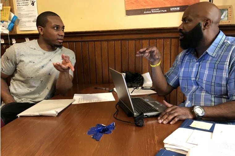 Michael West (left) works with Joe Robinson of the Pennsylvania society to put together West's first real resume. West spent 14 years in prison. He was released on May 3. 