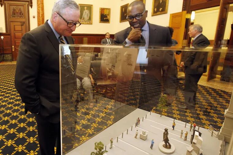 Sculptor Branly Cadet and Mayor  Kenney look over the model design for the Octavius Catto sculpture memorial.