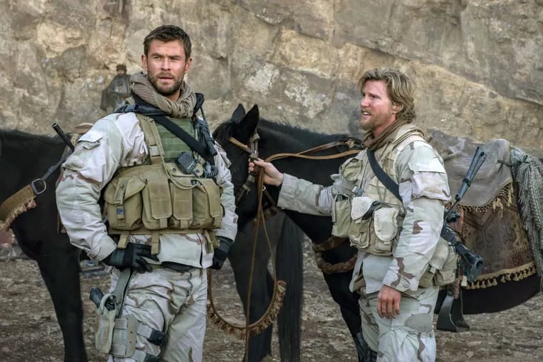 Chris Hemsworth ( left,) and Thad Luckinbill in “12 Strong.”