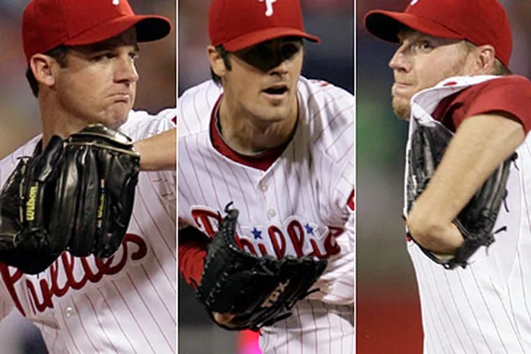 Roy Oswalt, left, Cole Hamels and Roy Halladay all share the same determination to win. (Yong Kim / Staff Photographer)