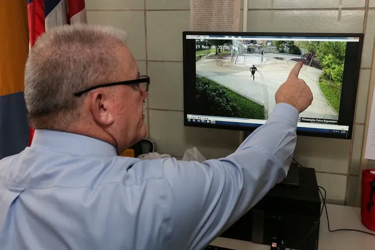 Northwest Detectives Division Capt. Frank McIlhenny looks over crime scene video of a shooting at the Dorothy Emanuel Playground, pointing to children who played on a playground set during the gun battle.