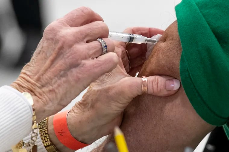Pat DeHorsey administers a COVID-19 vaccine to a health-care worker at Montgomery County Community College last week.
