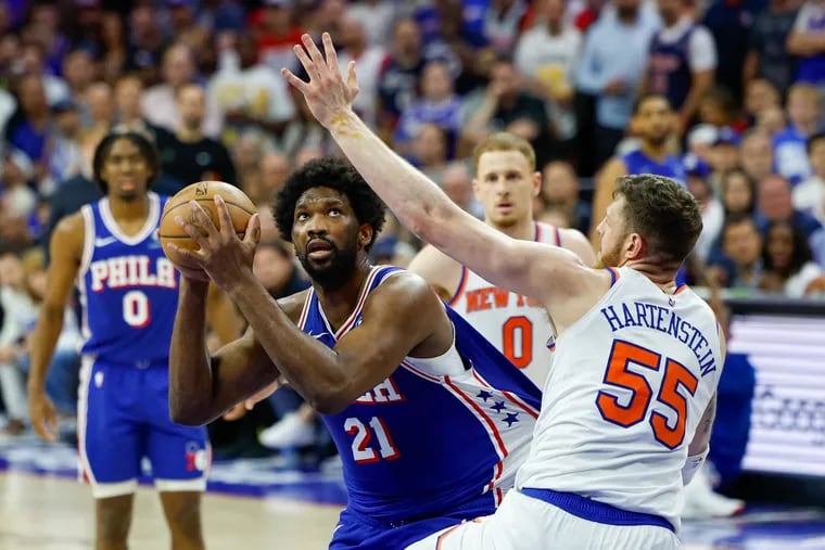 Sixers Joel Embiid lines up his shot against Knicks Isaiah Hartenstein during the third quarter of Game 6 in an NBA basketball first-round playoff series, Thursday, May 2, 2024, in Philadelphia.
