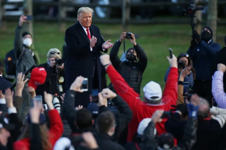President Donald Trump takes in cheers from the crowd at a campaign event at Headquarters Farm in Newtown on Saturday.