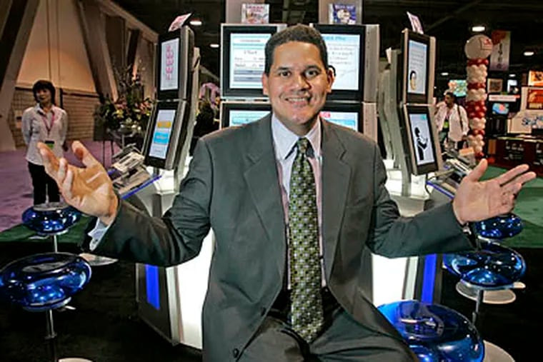 Reggie Fils-Aime, president of Nintendo of America, poses in front of the company's games at a conference in Long Beach, California in October 2008. (Lori Shepler / Los Angeles Times / MCT)