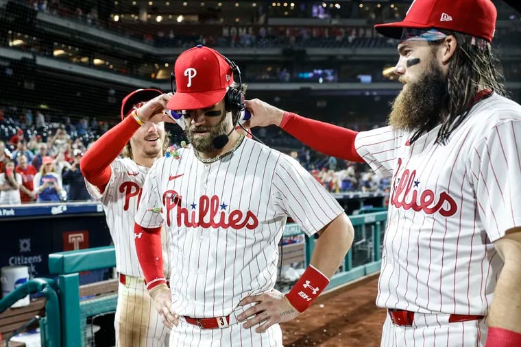 Bryce Harper, center, is enjoying the deep roster he hoped for in 2021, with young players such as Bryson Stott, left, and Brandon Marsh, right, emerging as core players.