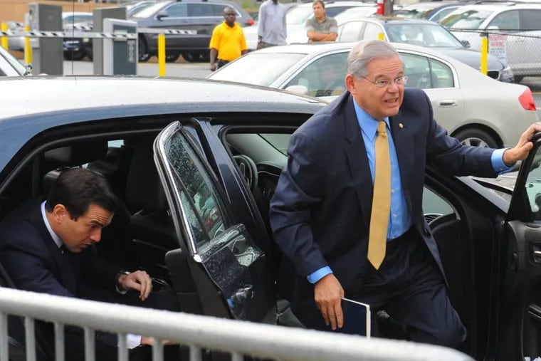 New Jersey Sen. Robert Menendez, right, and his son Robert Jr., enter a Newark, N.J. federal court on the first day of trial in his federal corruption case on September 5, 2017. (Louis Lanzano/Sipa USA/TNS)