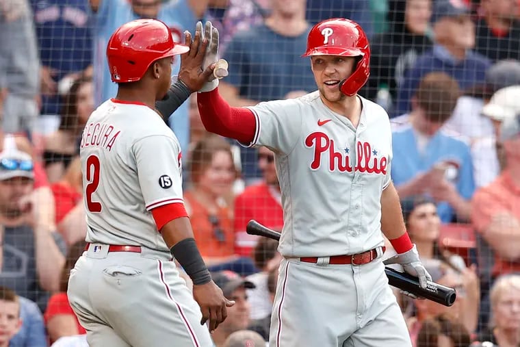 Phillies Rhys Hoskins (right) and Jean Segura celebrating during the eighth inning against the Red Sox at Fenway Park on Saturday as the Phillies took two of three entering the All-Star break.