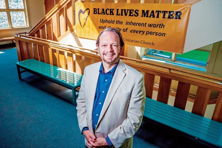 The Rev. Neal Jones in front of the Black Lives Matter banner at Main Line Unitarian Church in Devon. The church will dedicate the banner on Saturday, when it will be hung outside the entrance.