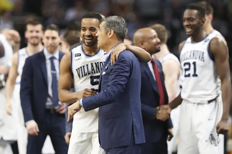 Villanova guard Phil Booth and coach Jay Wright celebrate at the end of the NCAA championship game.