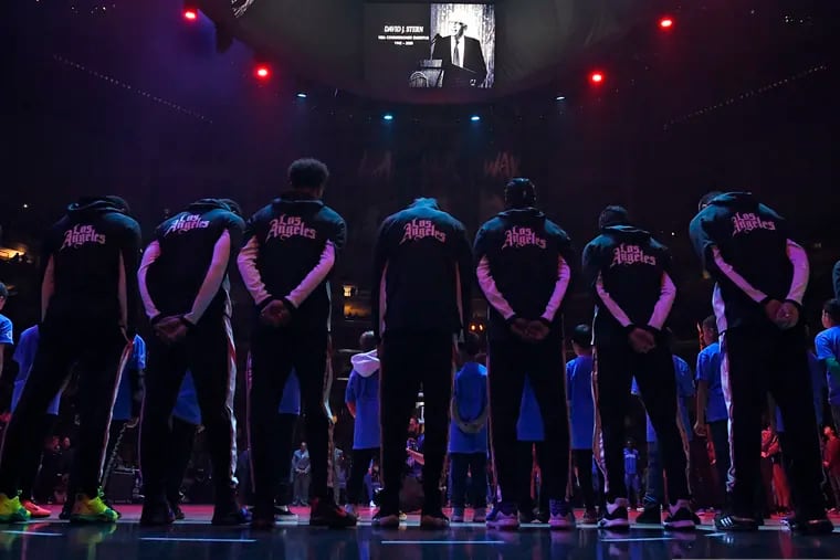 Members of the Los Angeles Clippers stood during a moment of silence Thursday, before a game against the Detroit Pistons, for former NBA Commissioner David Stern, who had died Wednesday.