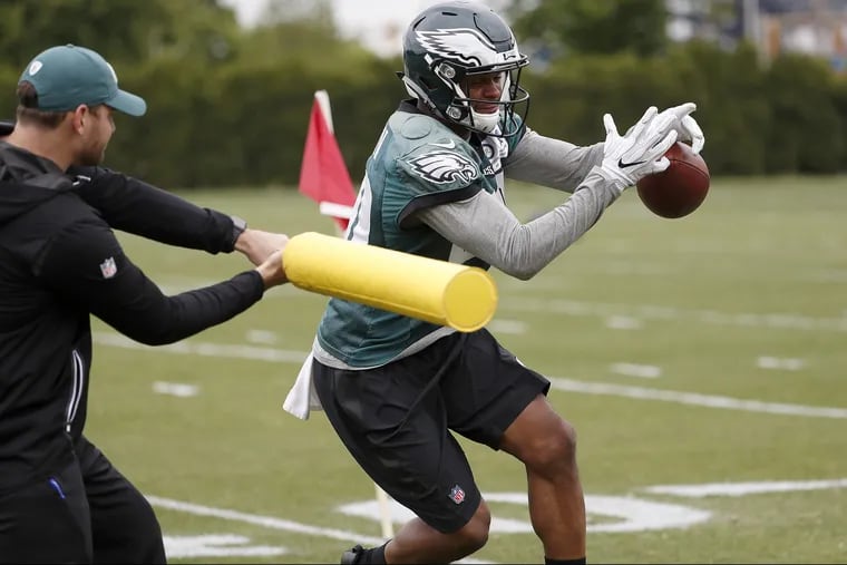 Tuesday's first day of live tackling at training camp resulted in Shelton Gibson taking a hit much harder than this foam bat tap during a drill last season. DAVID MAIALETTI / Staff Photographer