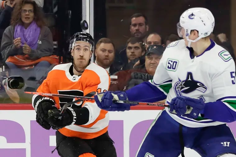 Flyers right wing Kevin Hayes watches the puck against Vancouver Canucks defenseman Tyler Myers during the second-period on Monday.