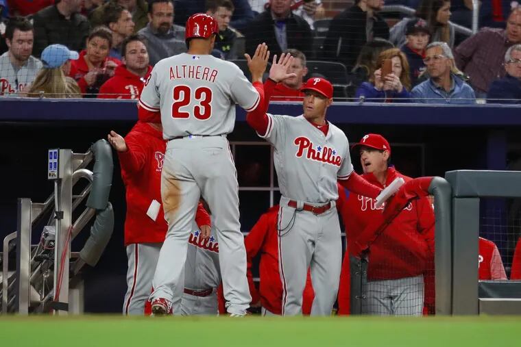 Phillies outfielder Aaron Altherr (left) celebrates scoring a run with manager Gabe Kapler in the sixth inning of the Phillies' 5-4 win on Friday.