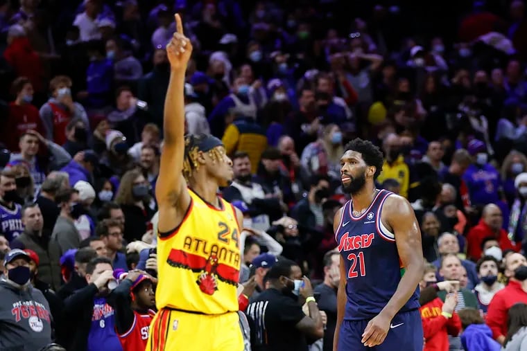 Sixers center Joel Embiid walks off the court after missing a last second basket against Atlanta Hawks forward Wes Iwundu on Thursday.  The Sixers lost to the Hawks 98-96.