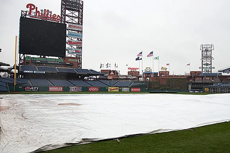 A tarp covers the field at Citizens Bank Park. (Chris Szagola/AP)