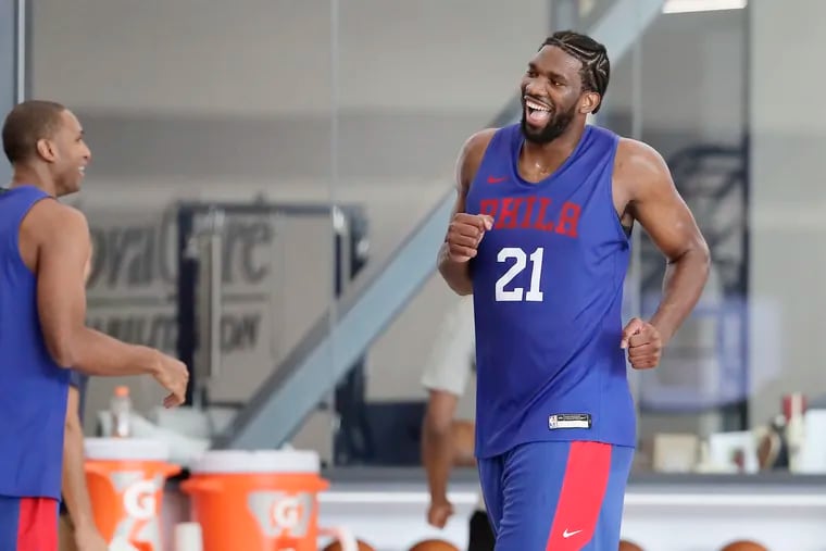 Sixers Joel Embiid (21) and Al Horford share a laugh after competing in a post-practice drill on Friday.