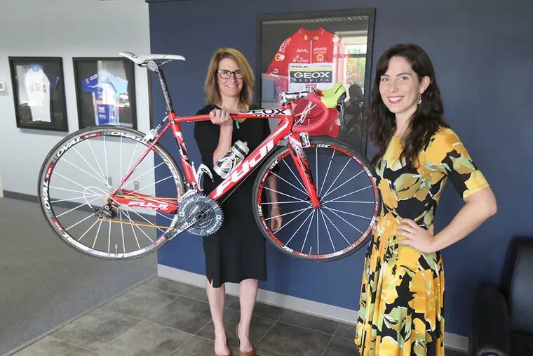 Karen Bliss (left) director of marketing and a former competitive cyclist, and Stephanie Genuardi, marketing content manager for Advanced Sports International, which makes and sells bicycles. (DAVID SWANSON/Staff Photographer)