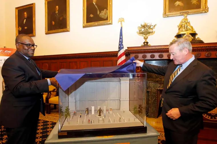 Mayor Kenney peeks at the model for the Octavius Catto sculpture memorial, along with sculptor Branly Cadet. The memorial will be placed in the southwest corner of City Hall.